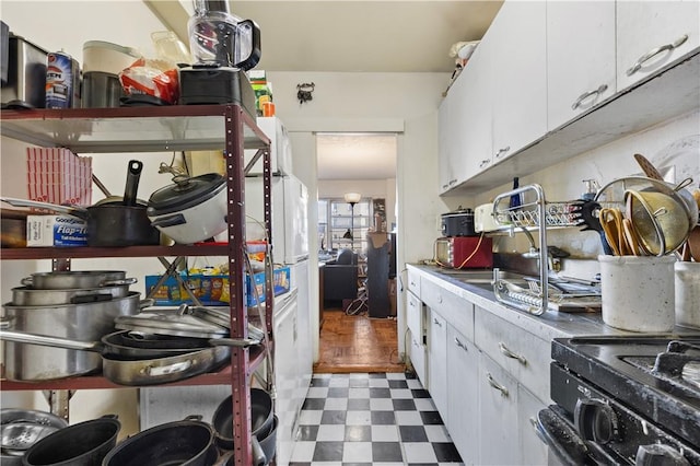 kitchen featuring white cabinetry, dark hardwood / wood-style floors, and black range with electric cooktop