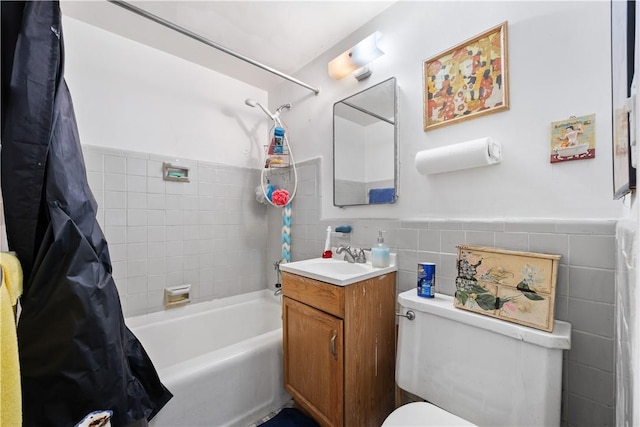 full bathroom with shower / bath combo with shower curtain, vanity, tile walls, and toilet