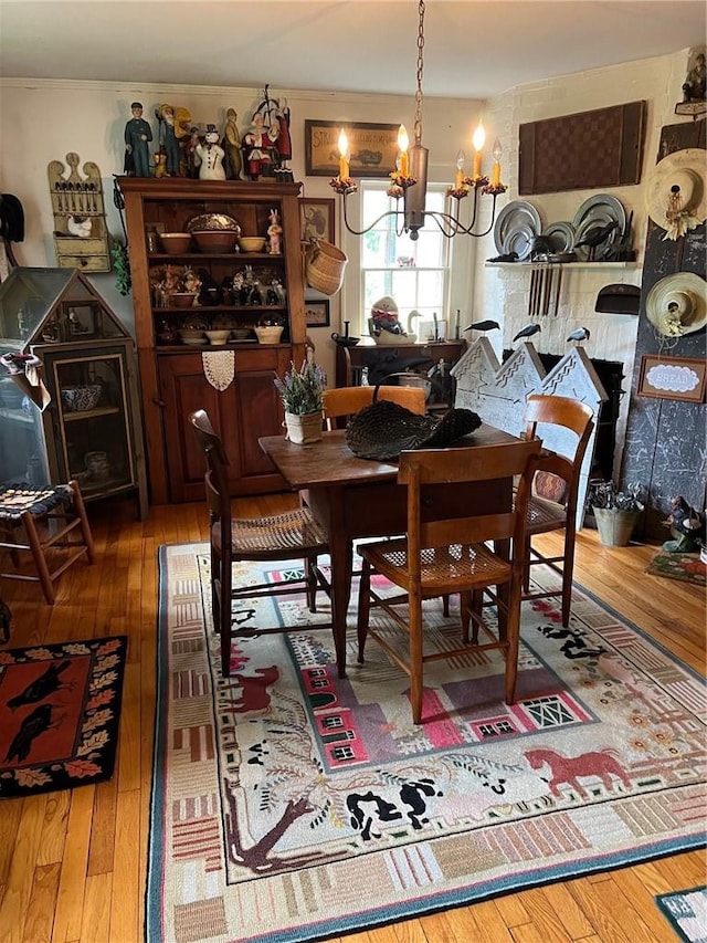 dining room with hardwood / wood-style flooring and an inviting chandelier