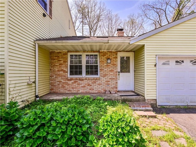 doorway to property with a garage