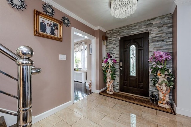 tiled entryway with crown molding and an inviting chandelier