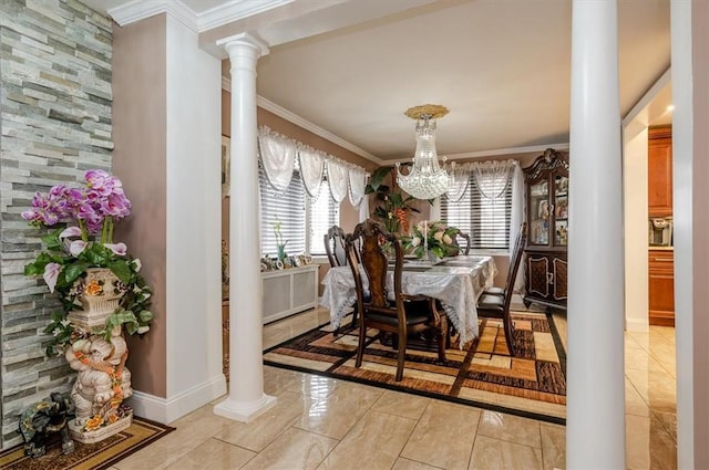 dining room with ornate columns, crown molding, and a chandelier