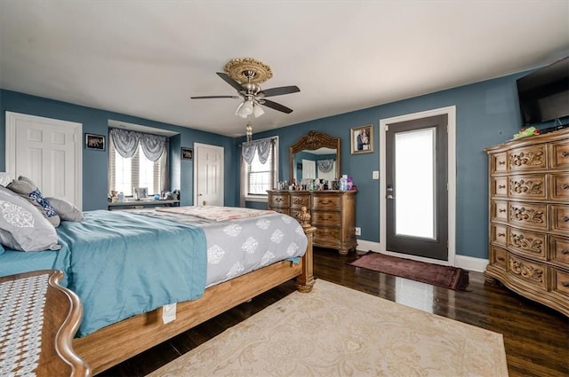 bedroom with ceiling fan and dark wood-type flooring