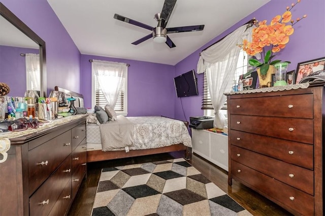 bedroom with dark hardwood / wood-style floors and ceiling fan