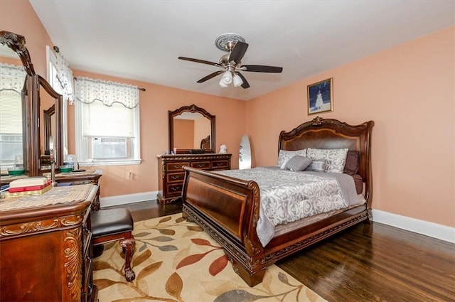 bedroom featuring dark hardwood / wood-style floors, multiple windows, and ceiling fan