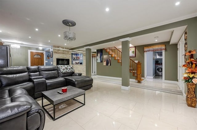 home theater room with light tile patterned floors, crown molding, and washer / clothes dryer