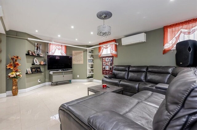 living room with a wall unit AC, light tile patterned floors, and a notable chandelier