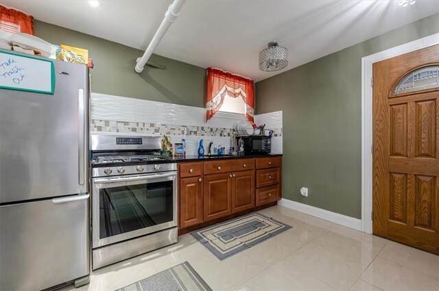 kitchen featuring stainless steel appliances and tasteful backsplash