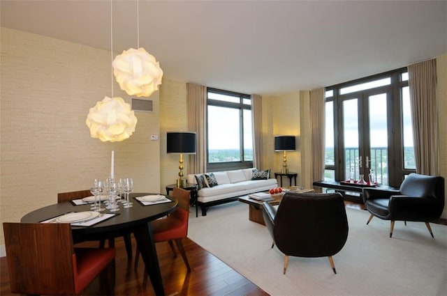 living room with french doors, wood-type flooring, and a wall of windows