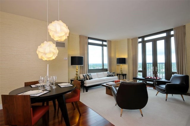 175 Huguenot St Unit 1607, New Rochelle, NY 10801 - living room with wood finished floors, a wall of windows, a chandelier, and french doors