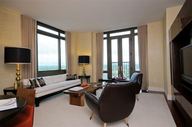 living room with french doors and a wall of windows