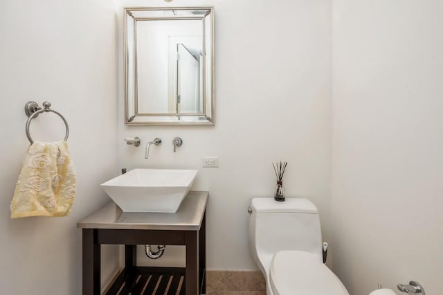 bathroom featuring tile patterned flooring, toilet, and sink