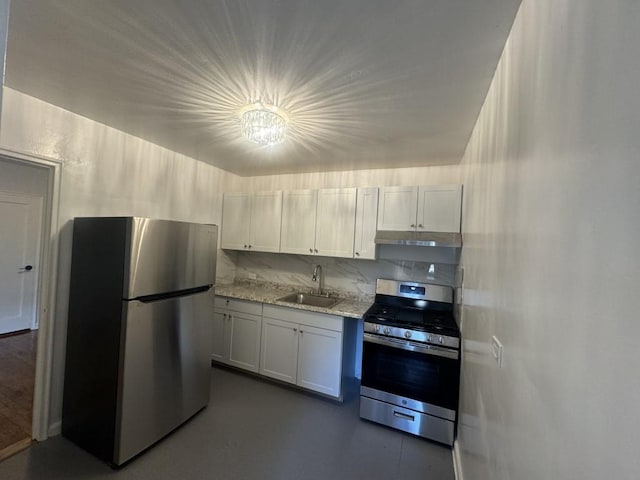 kitchen with sink, decorative backsplash, light stone counters, white cabinetry, and stainless steel appliances