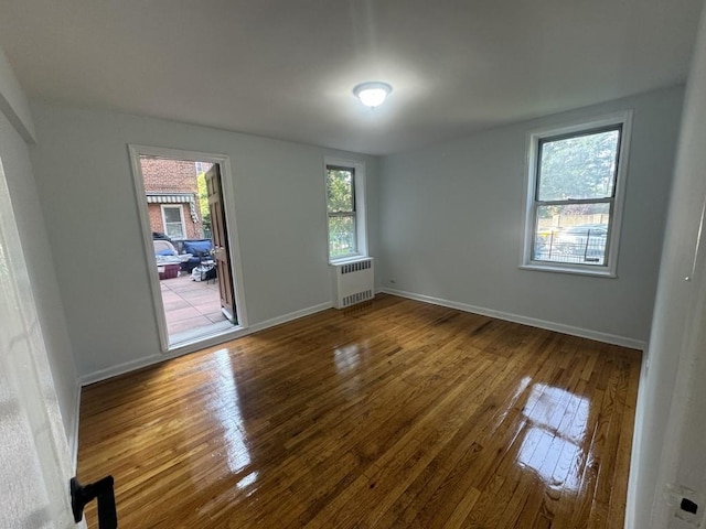 5639 Netherland Ave Unit 1B, Bronx, NY 10471 - unfurnished room with radiator, wood-type flooring, and baseboards