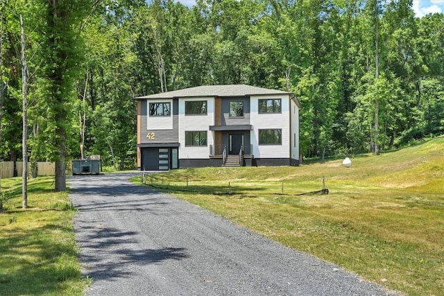 view of front of property with a garage and a front lawn