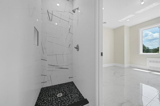 bathroom with radiator and tiled shower