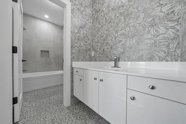 bathroom featuring vanity and tiled shower / bath