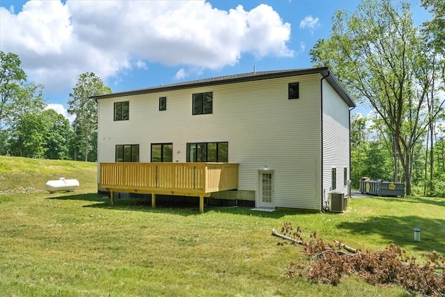 back of house with a yard, a wooden deck, and central AC