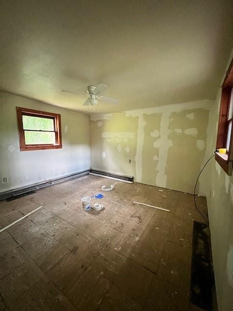 empty room featuring ceiling fan and a baseboard radiator