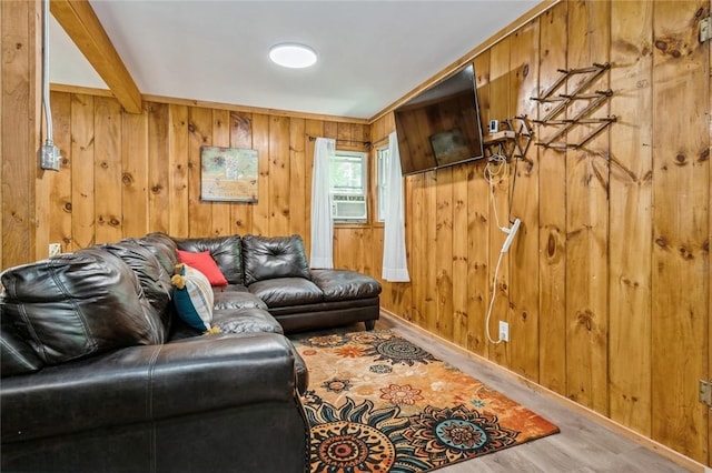 living room with wooden walls, cooling unit, and hardwood / wood-style flooring