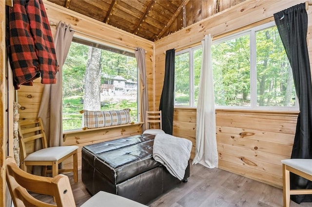 sunroom with plenty of natural light, wood ceiling, and vaulted ceiling