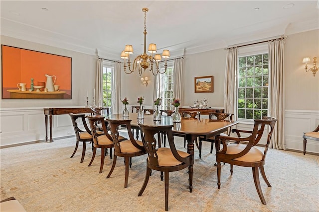 dining area featuring crown molding and a notable chandelier