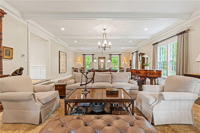 living room with a chandelier, light hardwood / wood-style floors, plenty of natural light, and crown molding