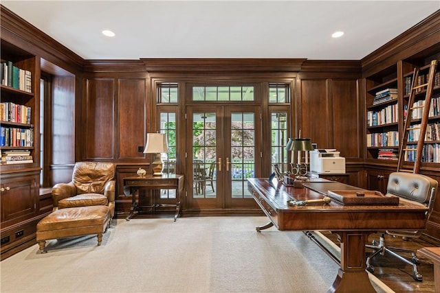 office featuring light carpet, french doors, and wooden walls