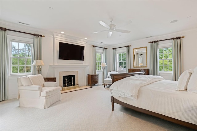 bedroom featuring light carpet, ceiling fan, and crown molding