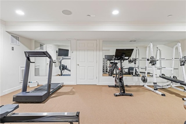 workout room featuring carpet and ornamental molding