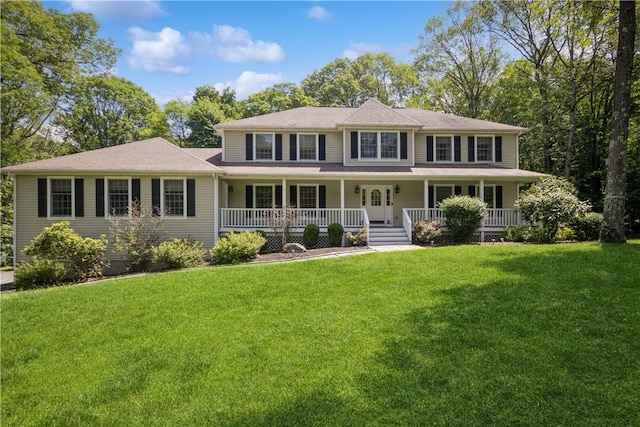 colonial-style house featuring covered porch and a front yard