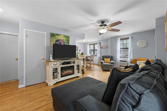 living room with ceiling fan and light wood-type flooring