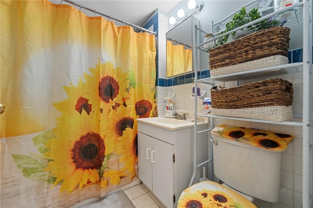 bathroom with walk in shower, vanity, tile walls, tile patterned flooring, and toilet