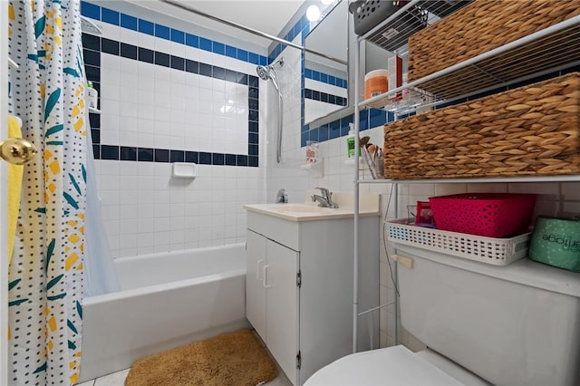 full bathroom with tile walls, vanity, shower / bath combo, and toilet