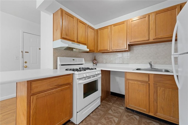 kitchen with decorative backsplash, sink, and white appliances