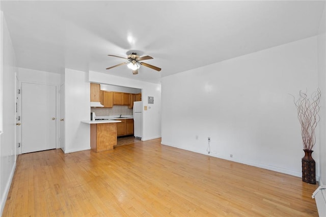 unfurnished living room with light hardwood / wood-style floors and ceiling fan