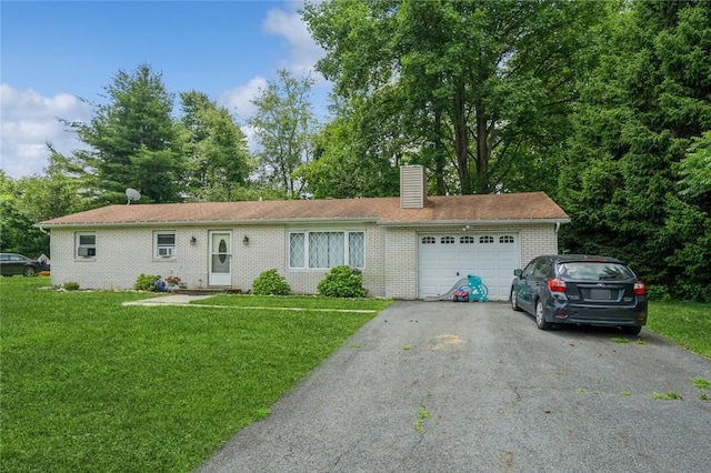 single story home featuring a garage, driveway, a front lawn, and a chimney