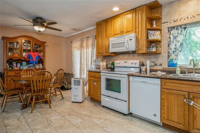 kitchen with white appliances, brown cabinetry, a sink, open shelves, and backsplash