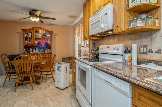 kitchen with dark stone counters, white appliances, a ceiling fan, and decorative backsplash