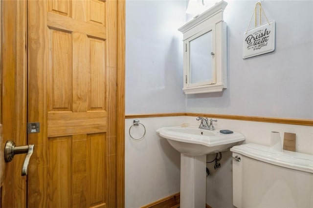 half bath featuring a sink and toilet