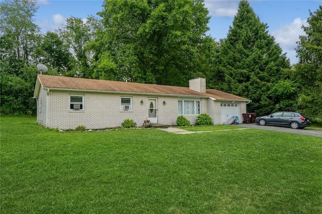 ranch-style house featuring aphalt driveway, brick siding, a chimney, a front yard, and a garage