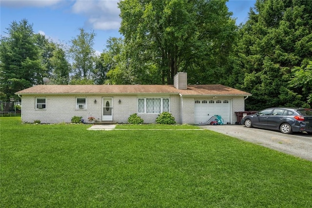 single story home featuring an attached garage, brick siding, driveway, a front lawn, and a chimney