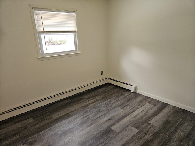 empty room featuring dark wood-style floors, a baseboard radiator, and baseboards