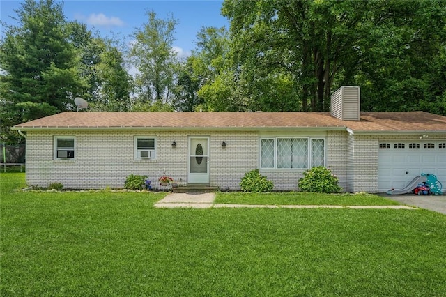 ranch-style house featuring brick siding, a chimney, an attached garage, and a front yard