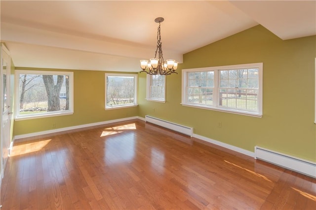 unfurnished dining area featuring baseboard heating, hardwood / wood-style floors, lofted ceiling, and a notable chandelier