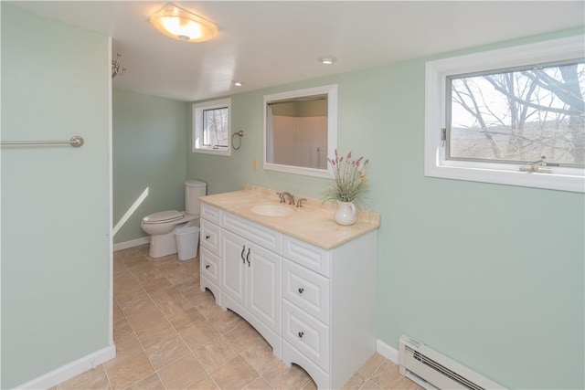 bathroom with tile patterned floors, vanity, toilet, and a baseboard heating unit