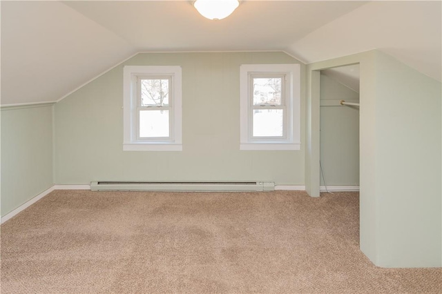 bonus room with light colored carpet, a healthy amount of sunlight, and lofted ceiling