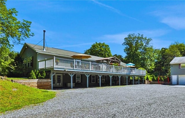 view of front of property featuring a garage and a wooden deck