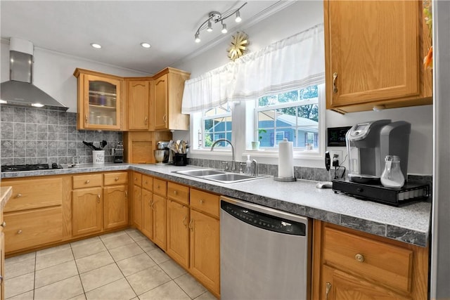 kitchen with stainless steel dishwasher, ornamental molding, gas stovetop, sink, and wall chimney range hood