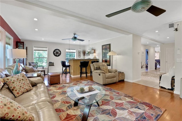 living room with light hardwood / wood-style floors and crown molding